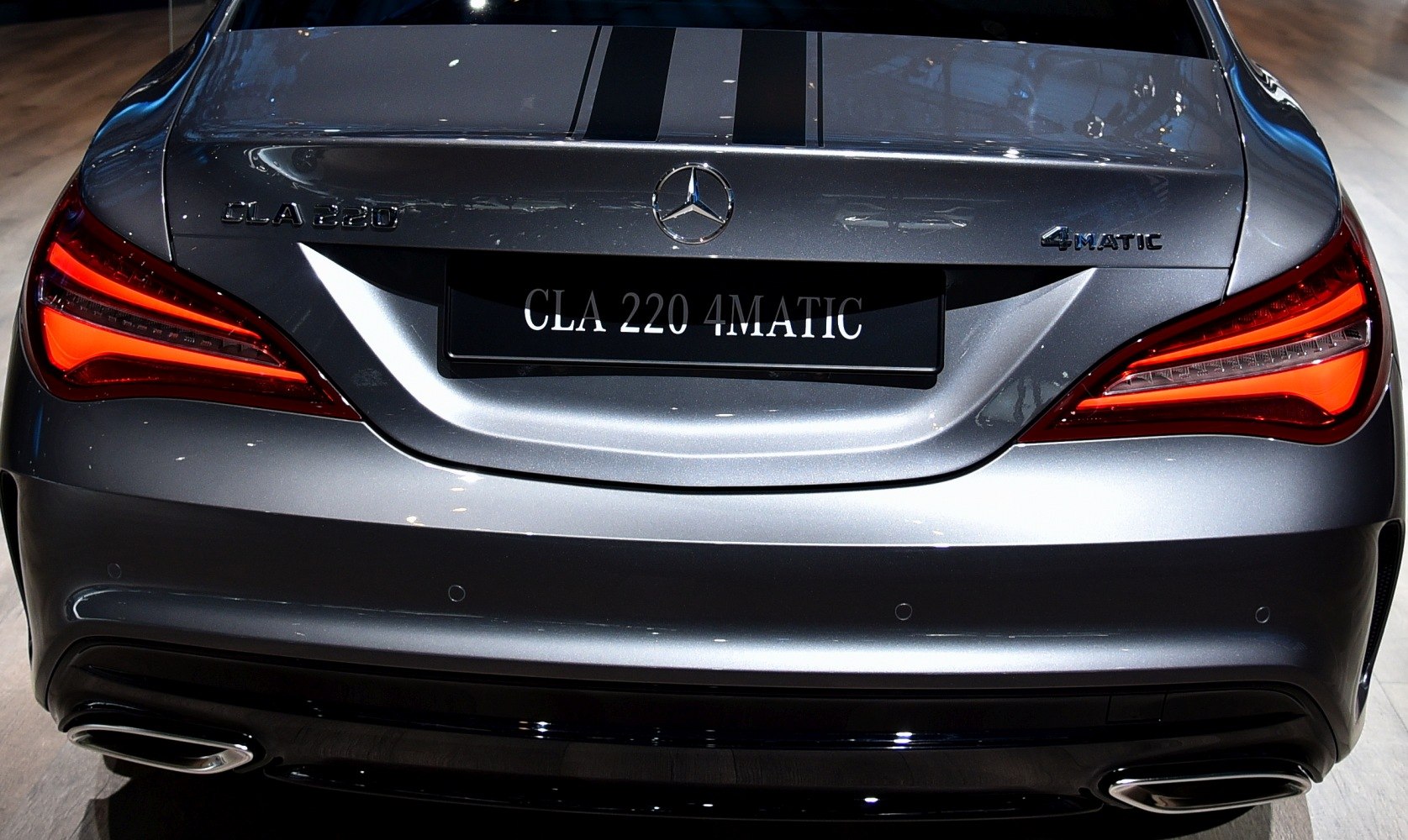 Rear view with illuminated tail lights and 4MATIC badge