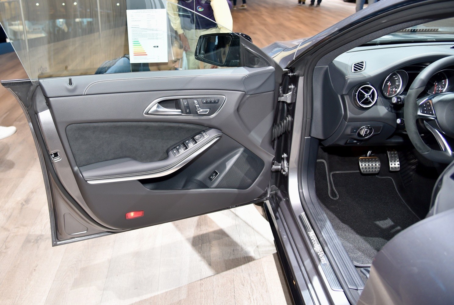 Interior door panel and dashboard details with controls and pedals