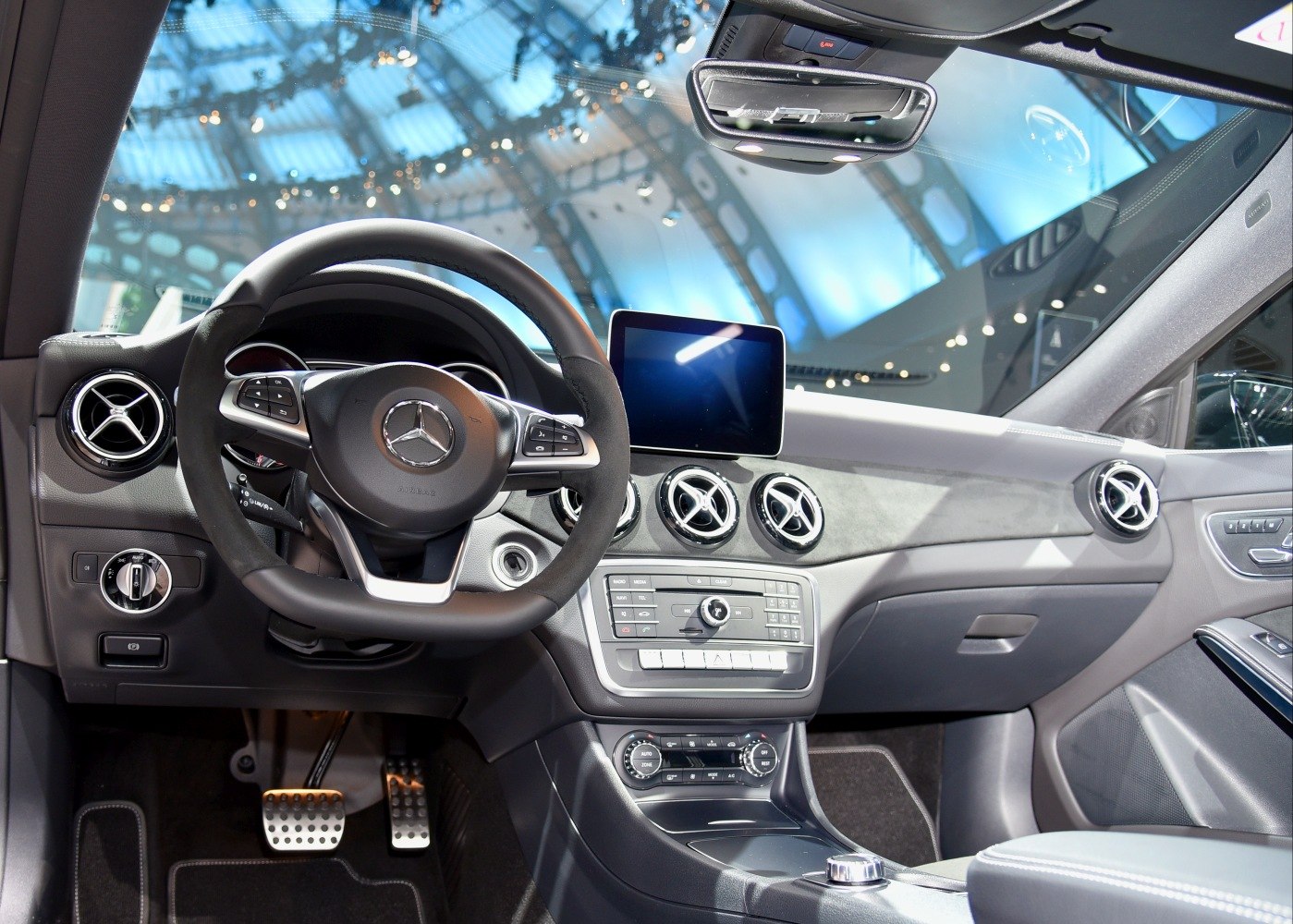 Luxury car interior with circular air vents and central infotainment display