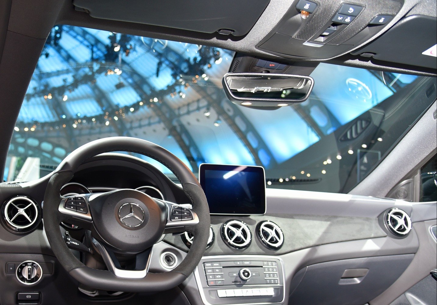 Dashboard and steering wheel with central infotainment screen and air vents