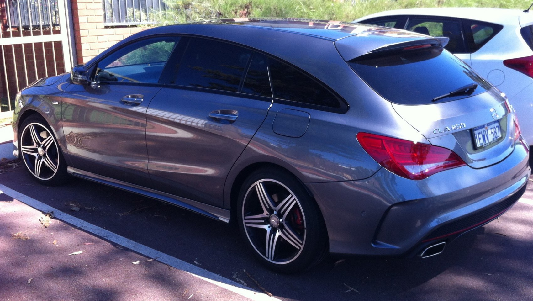 Rear and side view of sleek car with tinted windows and alloy wheels