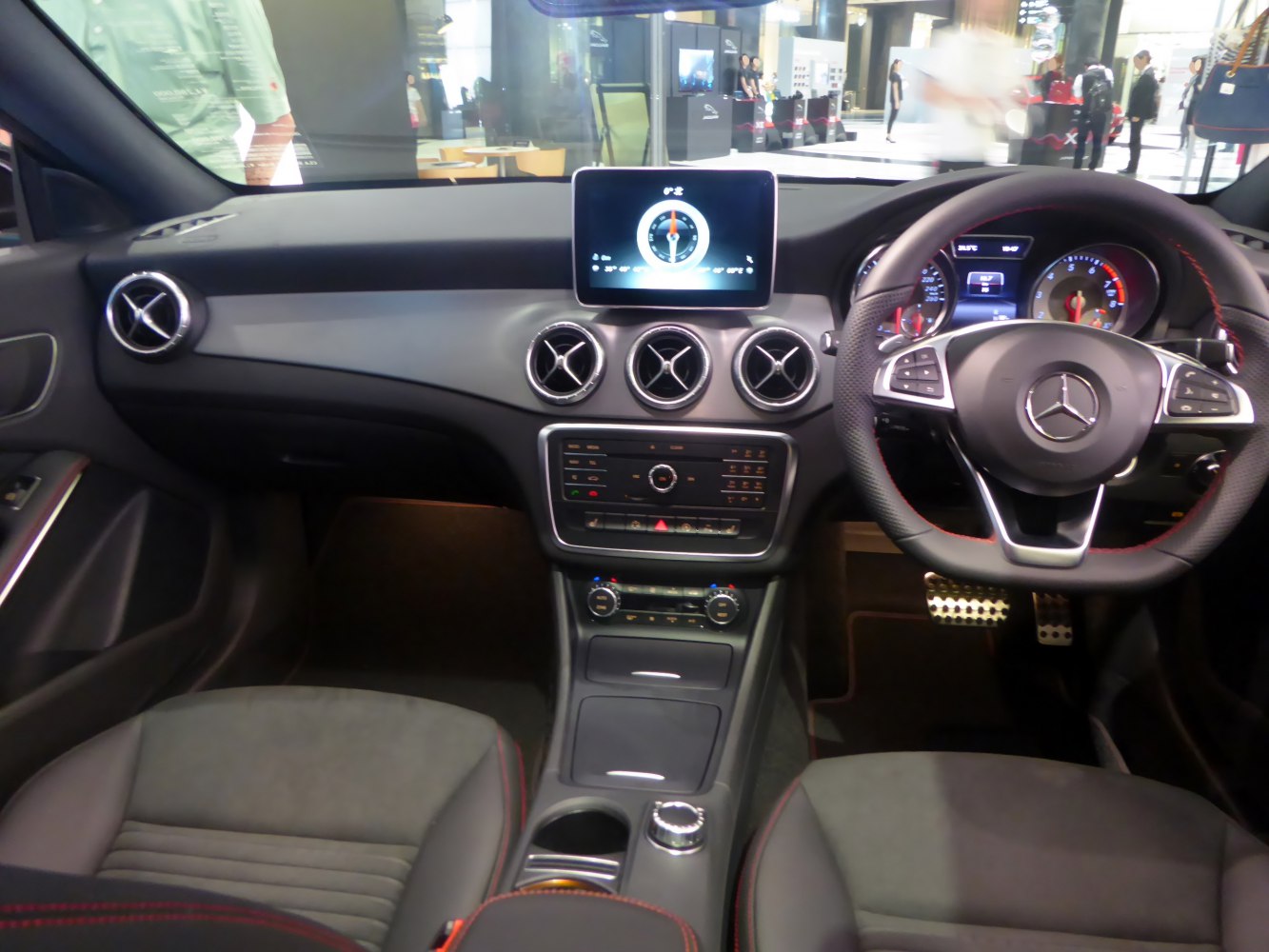 Modern dashboard and steering wheel with circular vents and digital display
