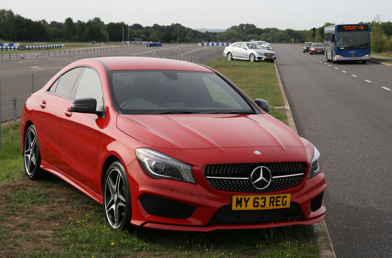 Front view of a red sporty coupe with distinctive grille and headlights