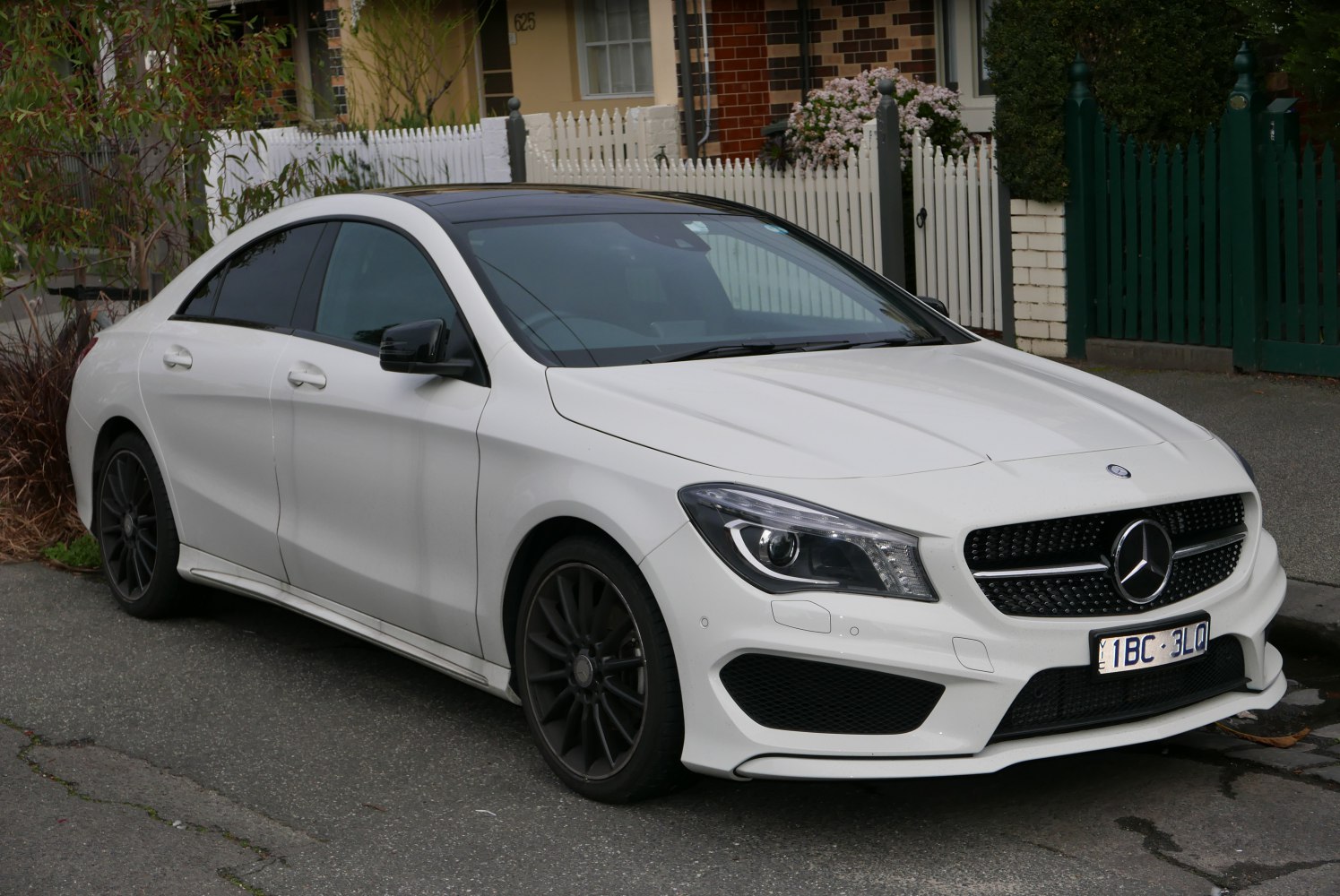Front side view with headlights and grille of a luxury coupe