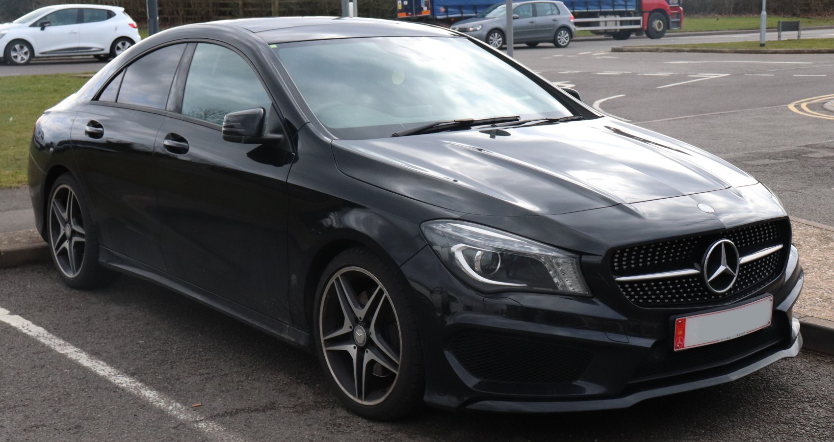 Black four-door coupe with diamond grille and projector headlights