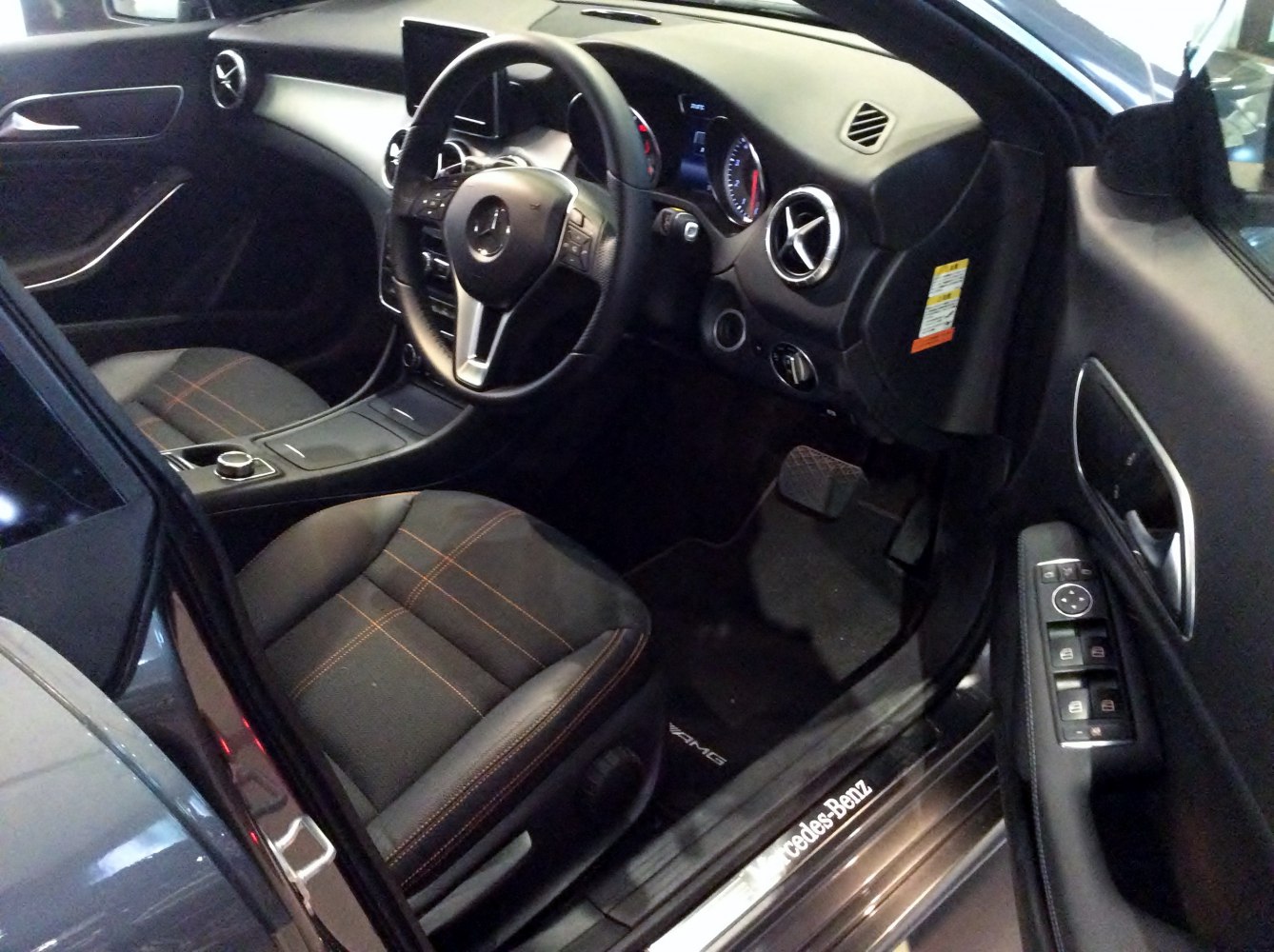 Modern luxury vehicle interior with sporty steering and control panel