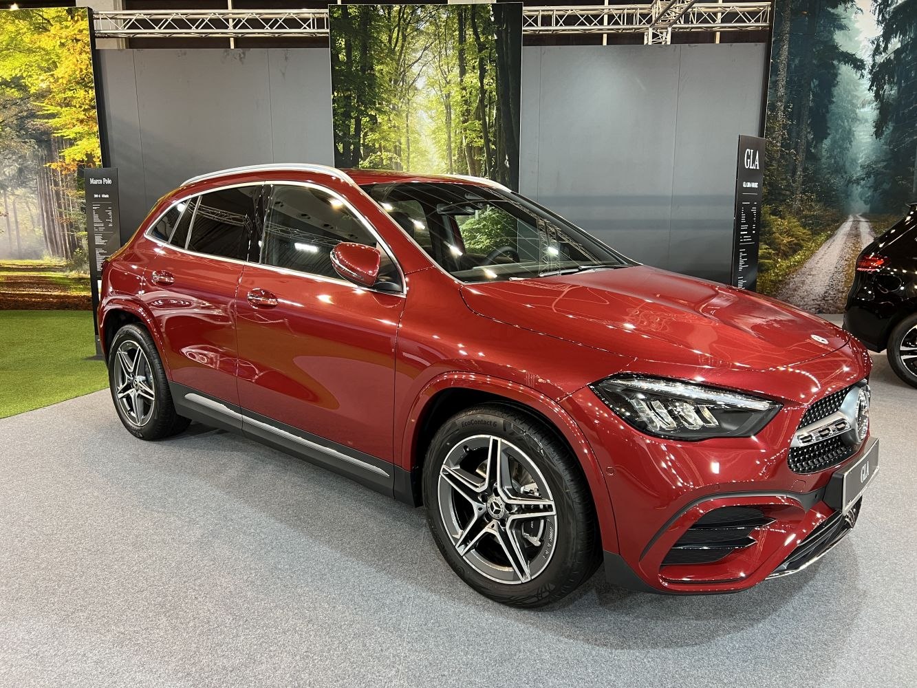 Front side view of red compact SUV with LED headlights and alloy wheels