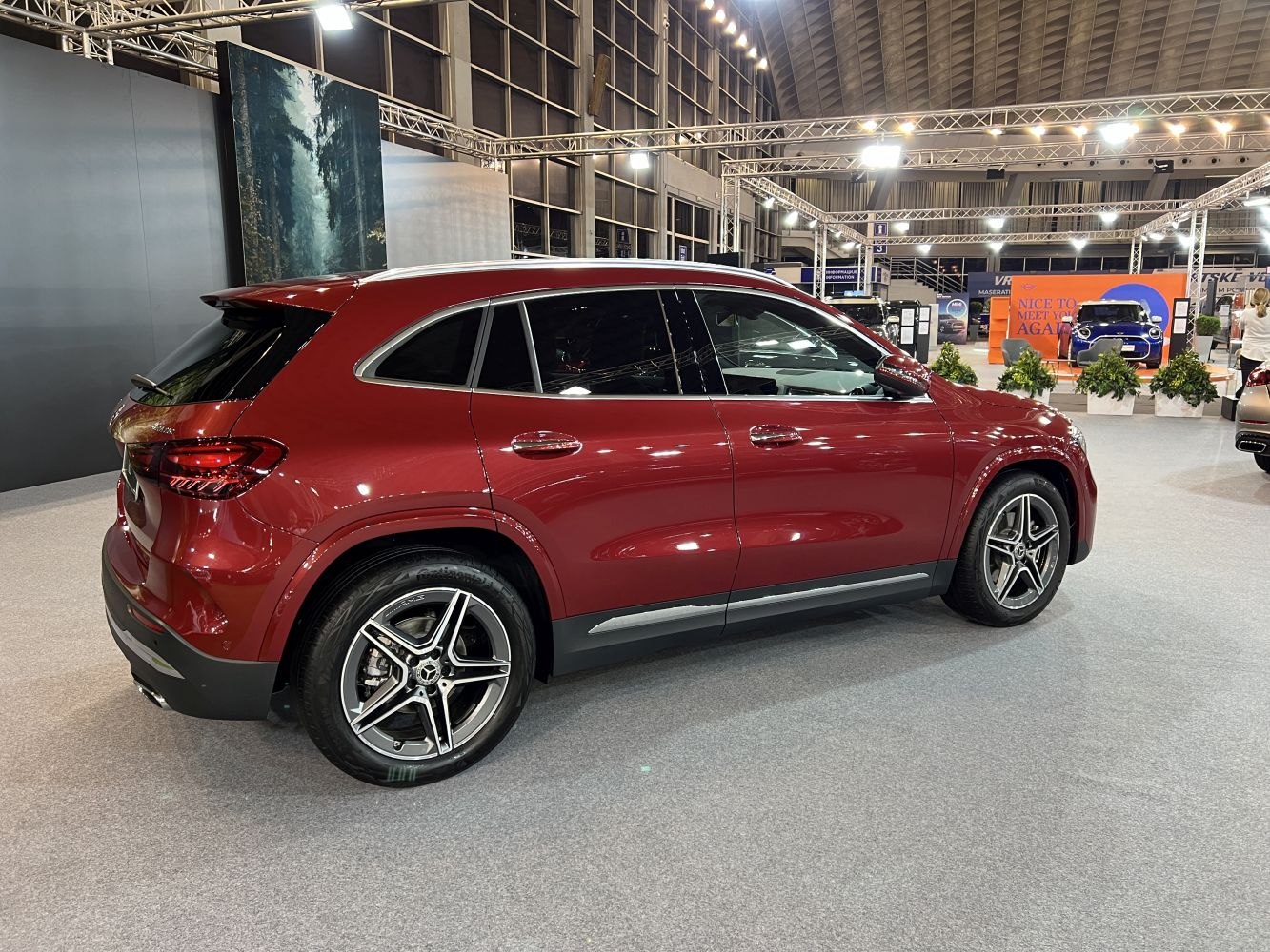Red compact SUV side profile with alloy wheels and tinted windows