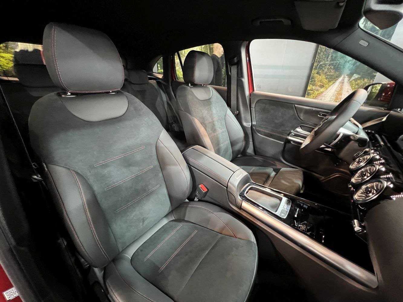 Luxury front seats and modern dashboard with console and steering wheel