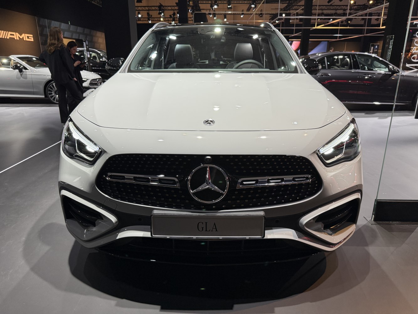 Close-up of modern LED headlights and prominent front grille.