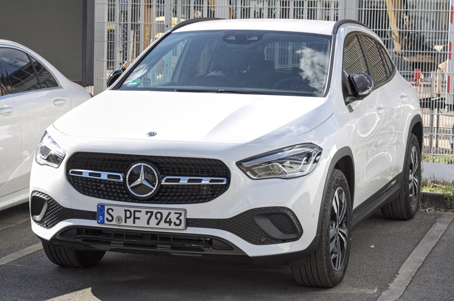 White SUV front with black grille and LED headlights