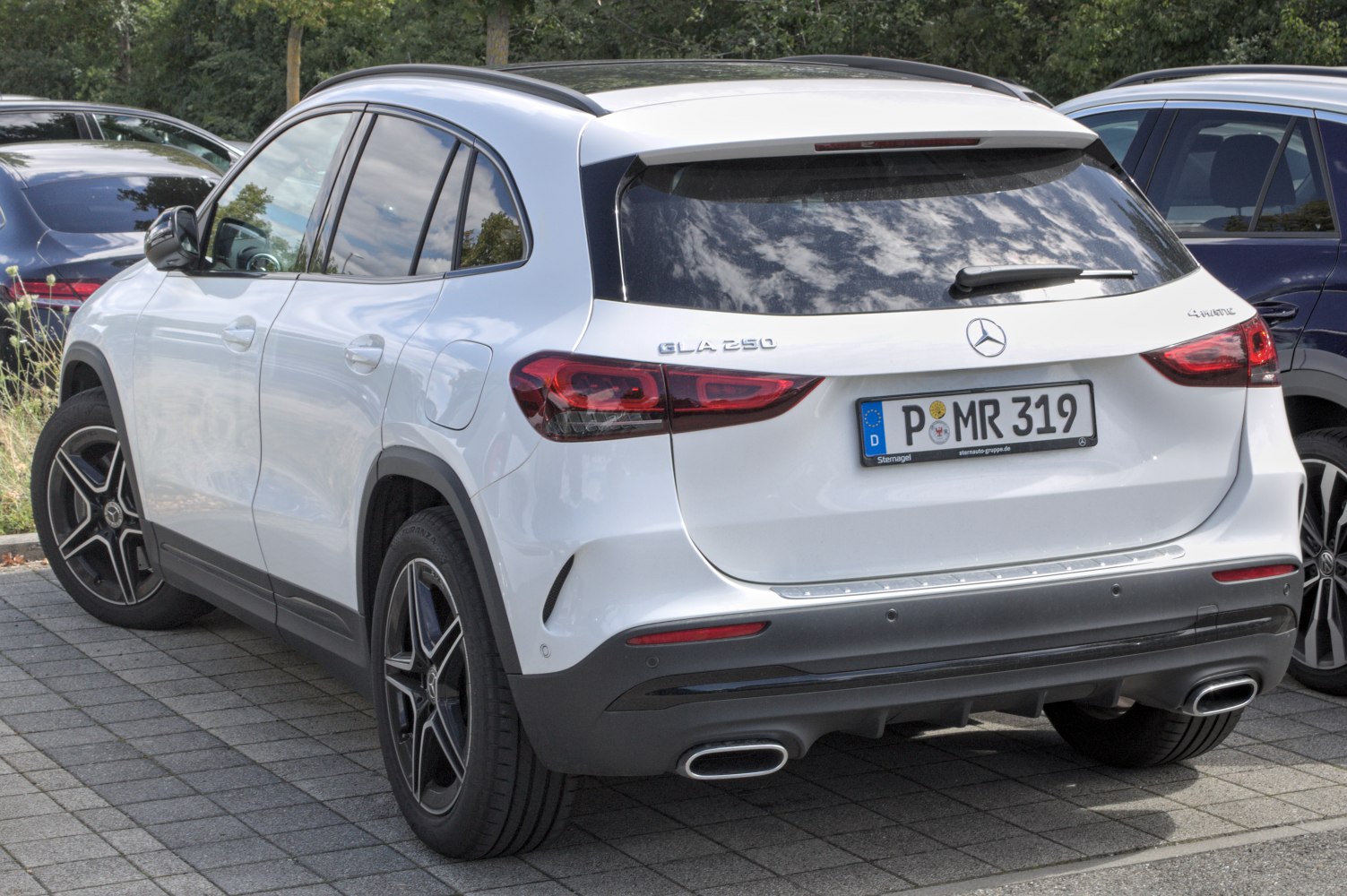 Rear view of white SUV with sleek taillights and dual exhausts