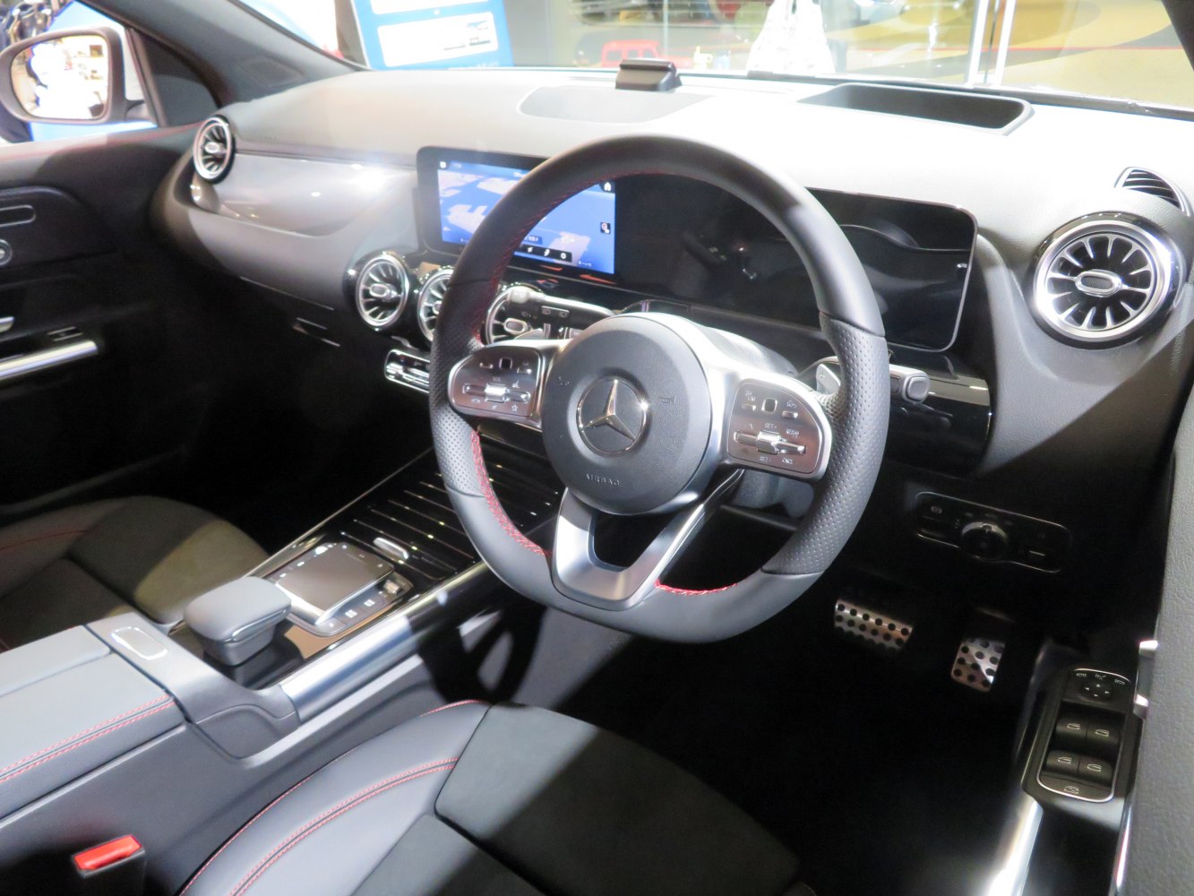 Digital dashboard and sporty steering wheel with center console and modern air vents.