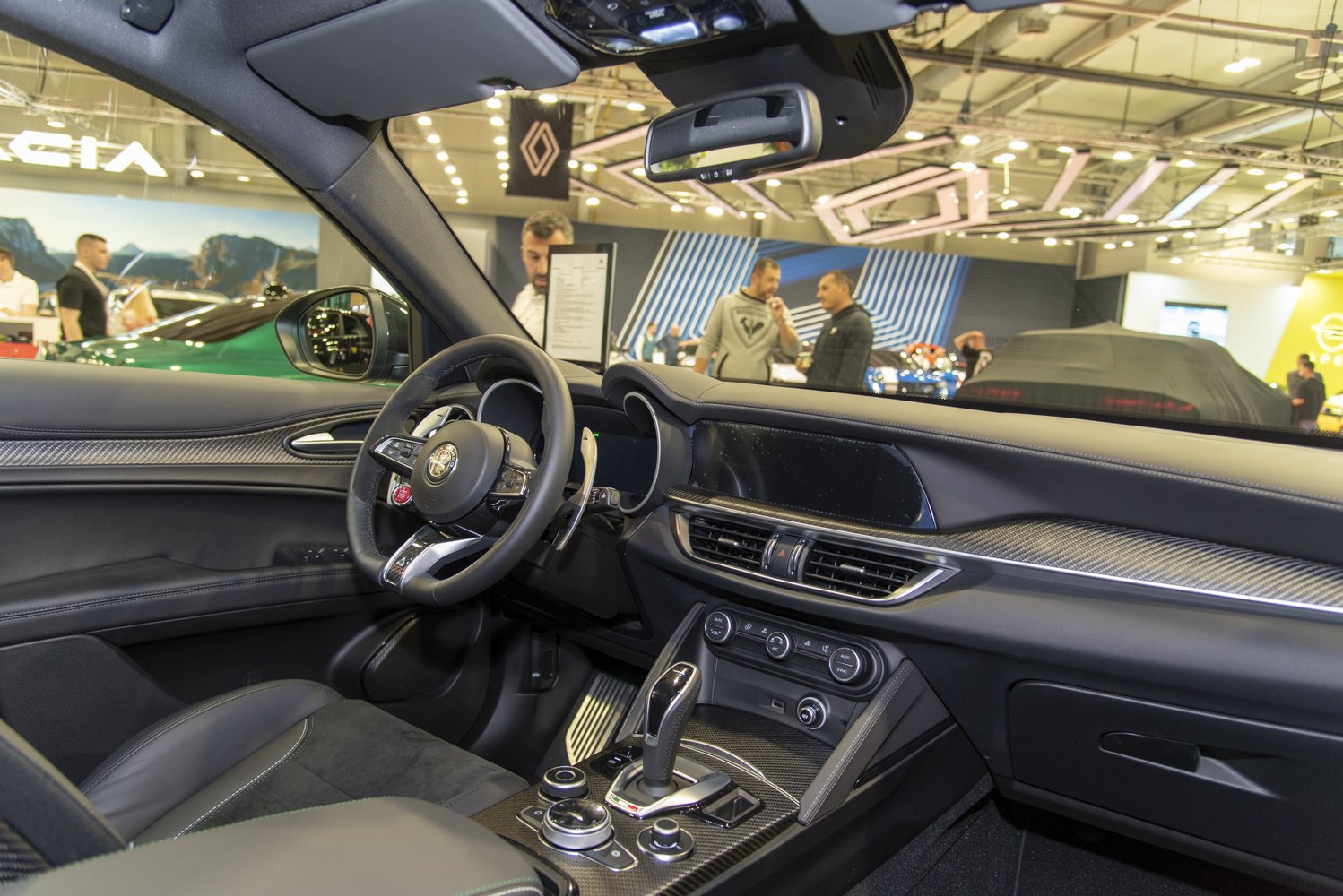 Interior with digital display, carbon fiber trim dashboard, and multifunction steering wheel