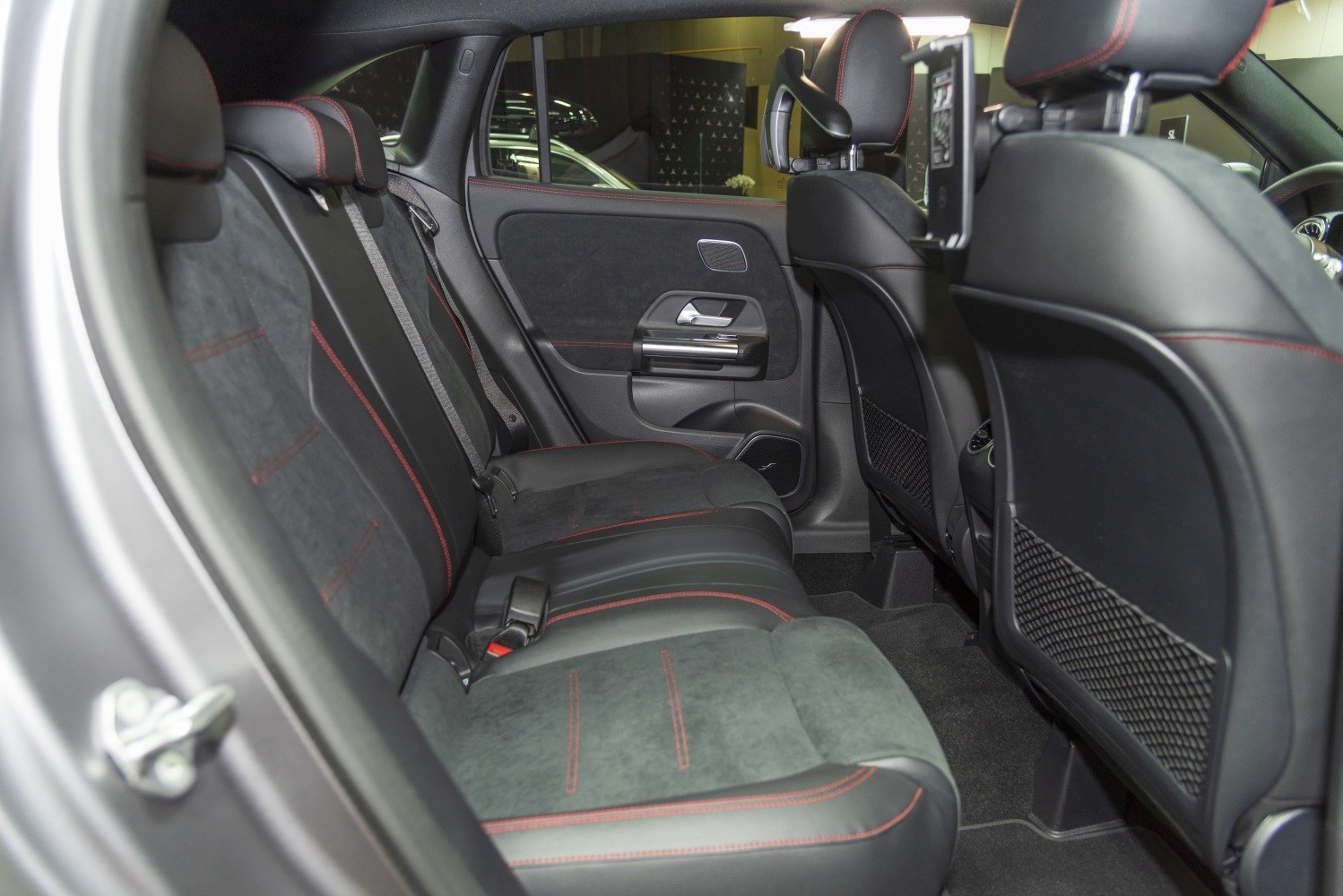Rear seat interior with black leather and red stitching