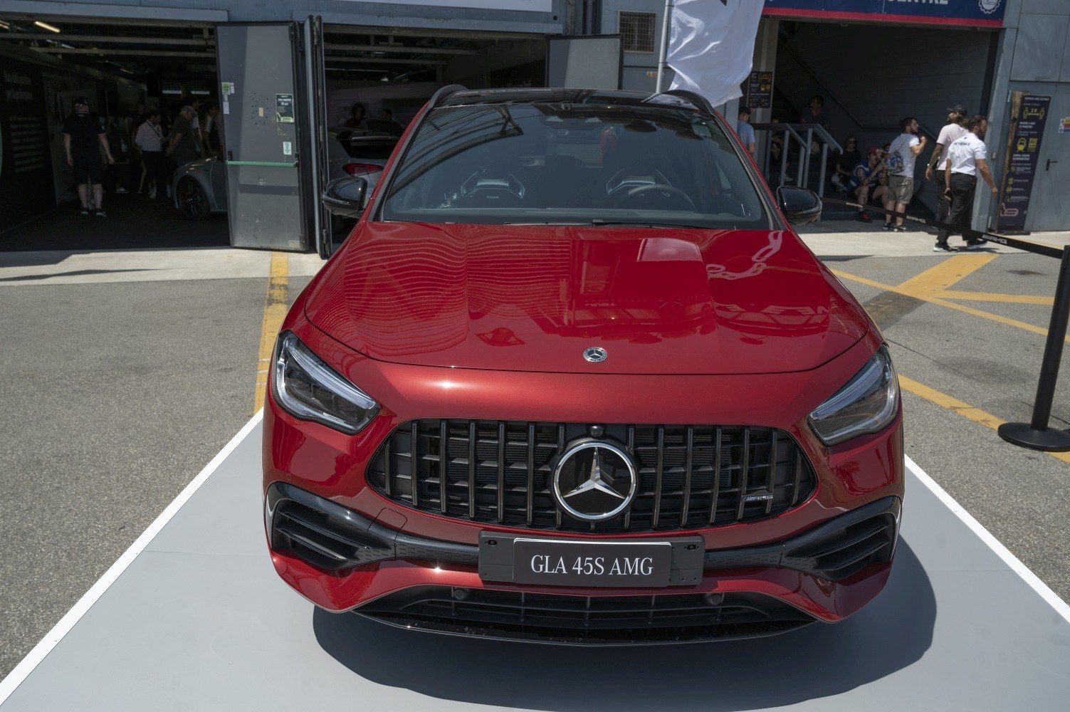 Aggressive front grille and headlights of a sporty red SUV.