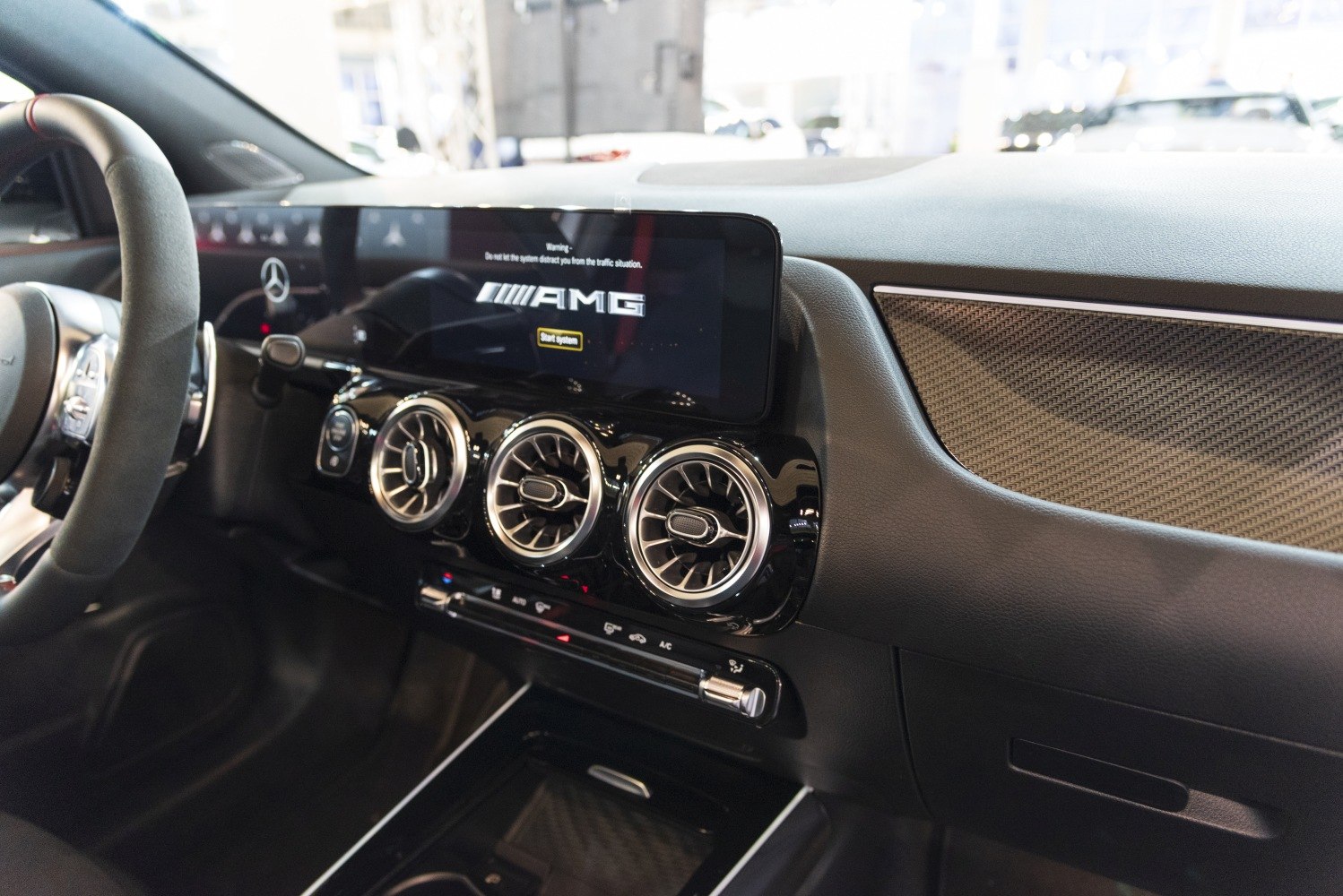 AMG digital display and three circular turbine-style air vents on dashboard