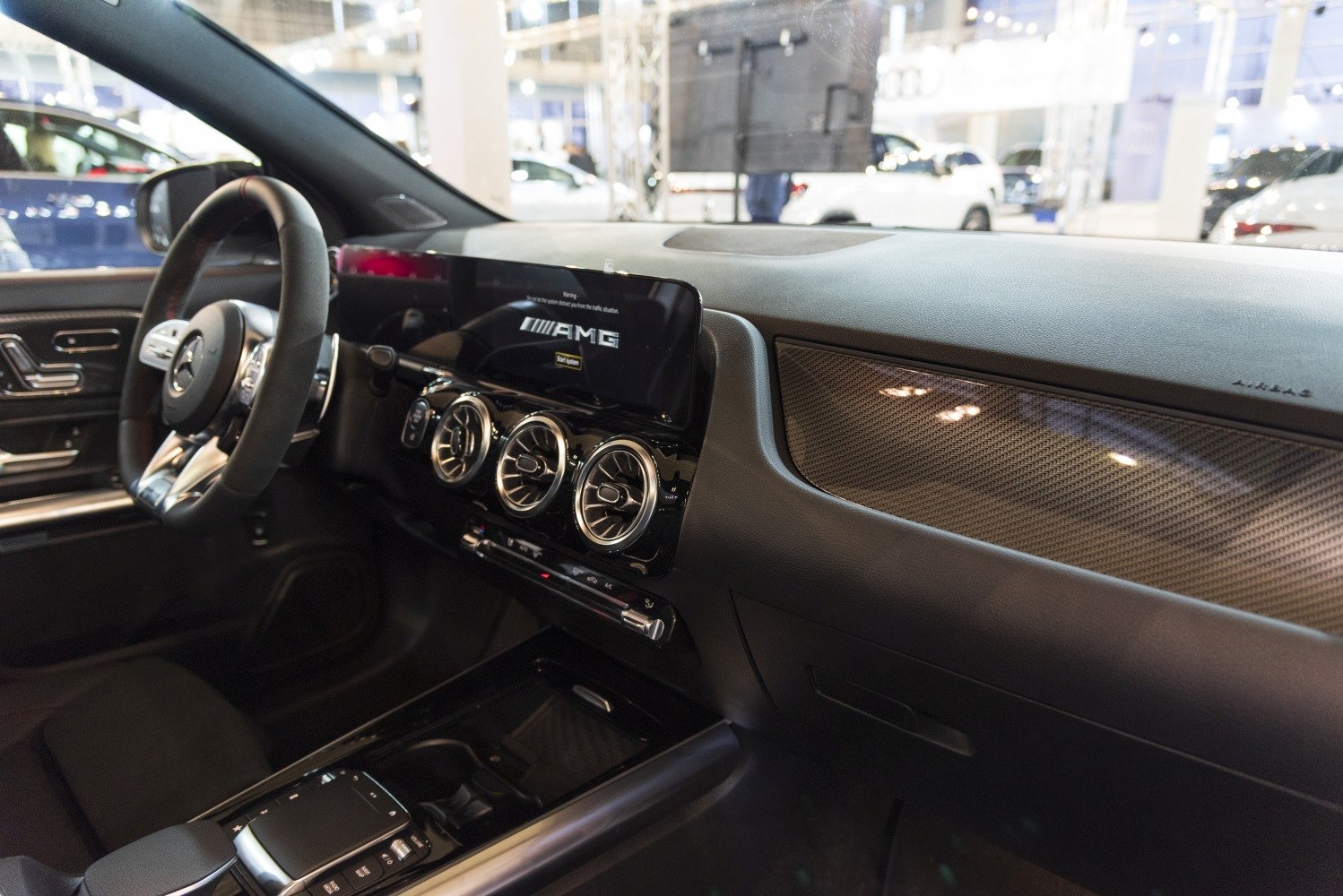 AMG digital display and circular air vents on modern dashboard.