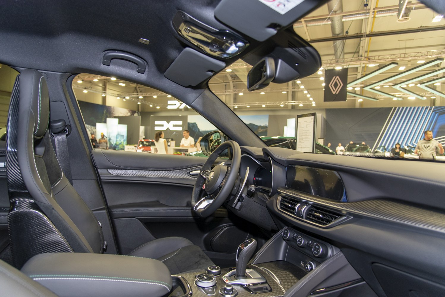 Carbon fiber trim interior with sporty front seats and modern dashboard.