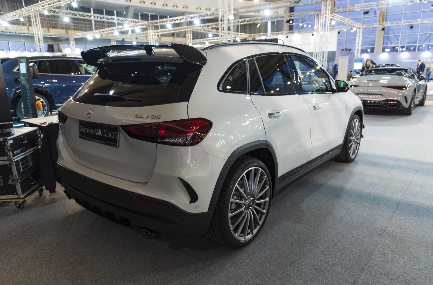 Rear and side view with taillights, alloy wheels, and roof spoiler