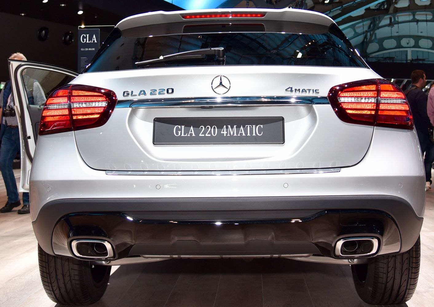 Rear end with taillights, badge emblems, and dual exhausts