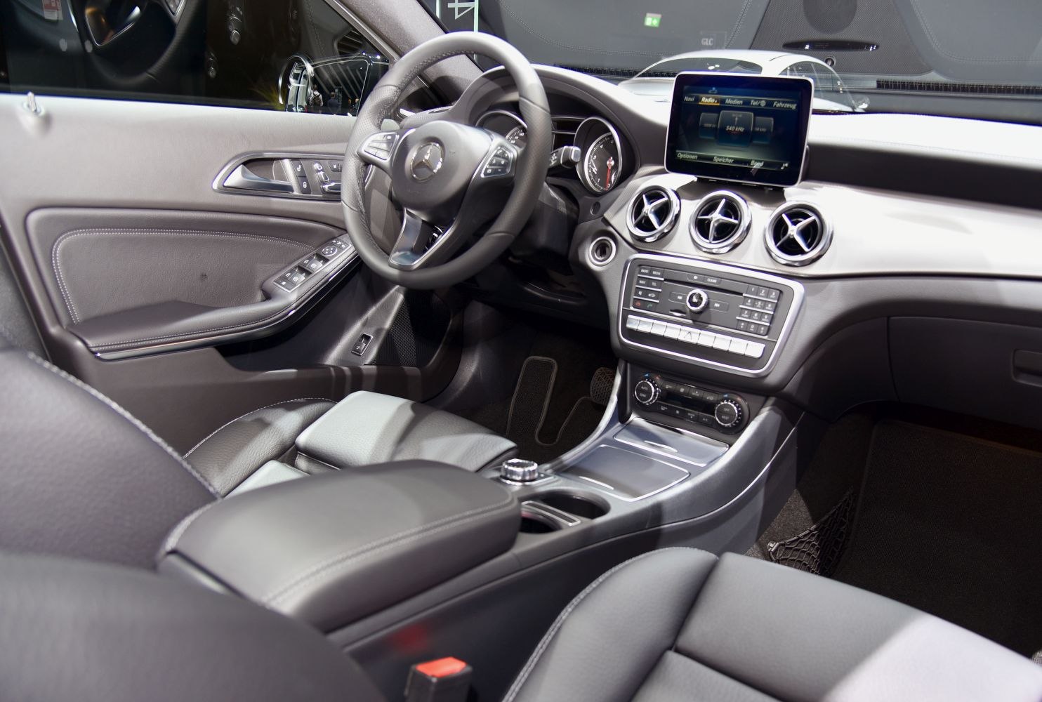 Luxury car interior dashboard with multimedia screen and steering wheel controls