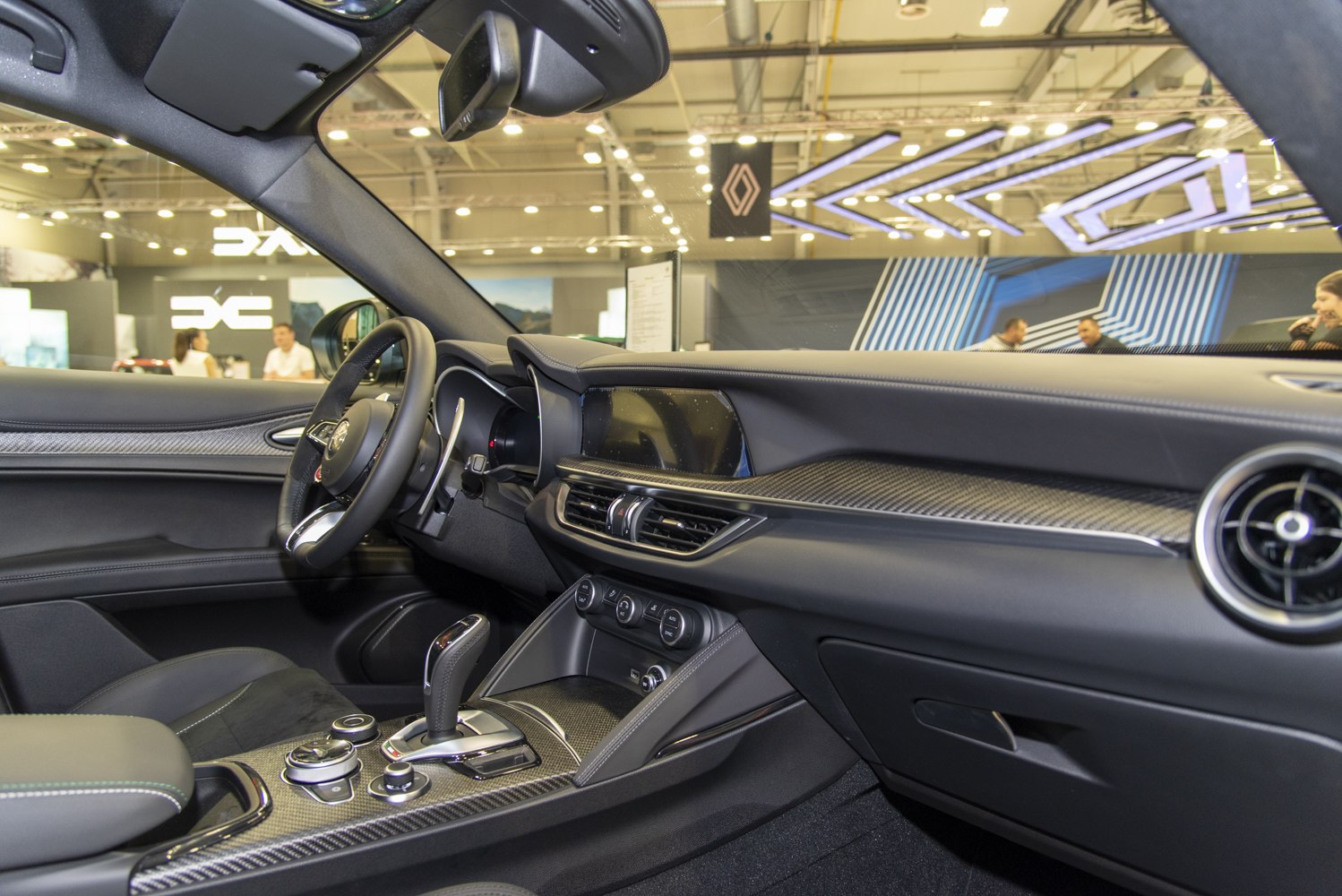 Interior with carbon fiber trim, modern controls, and round air vent