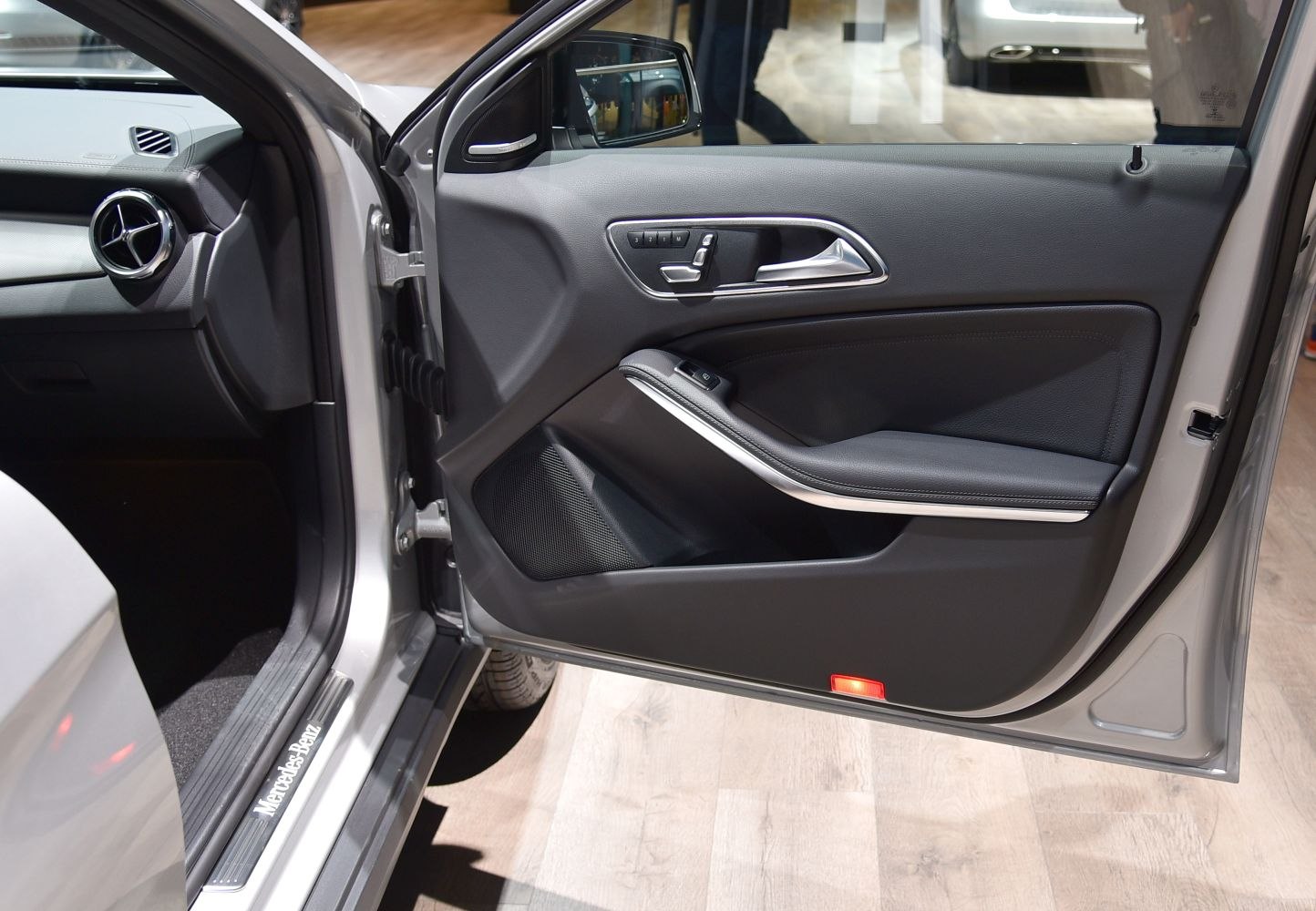 Front interior door panel with controls and trim