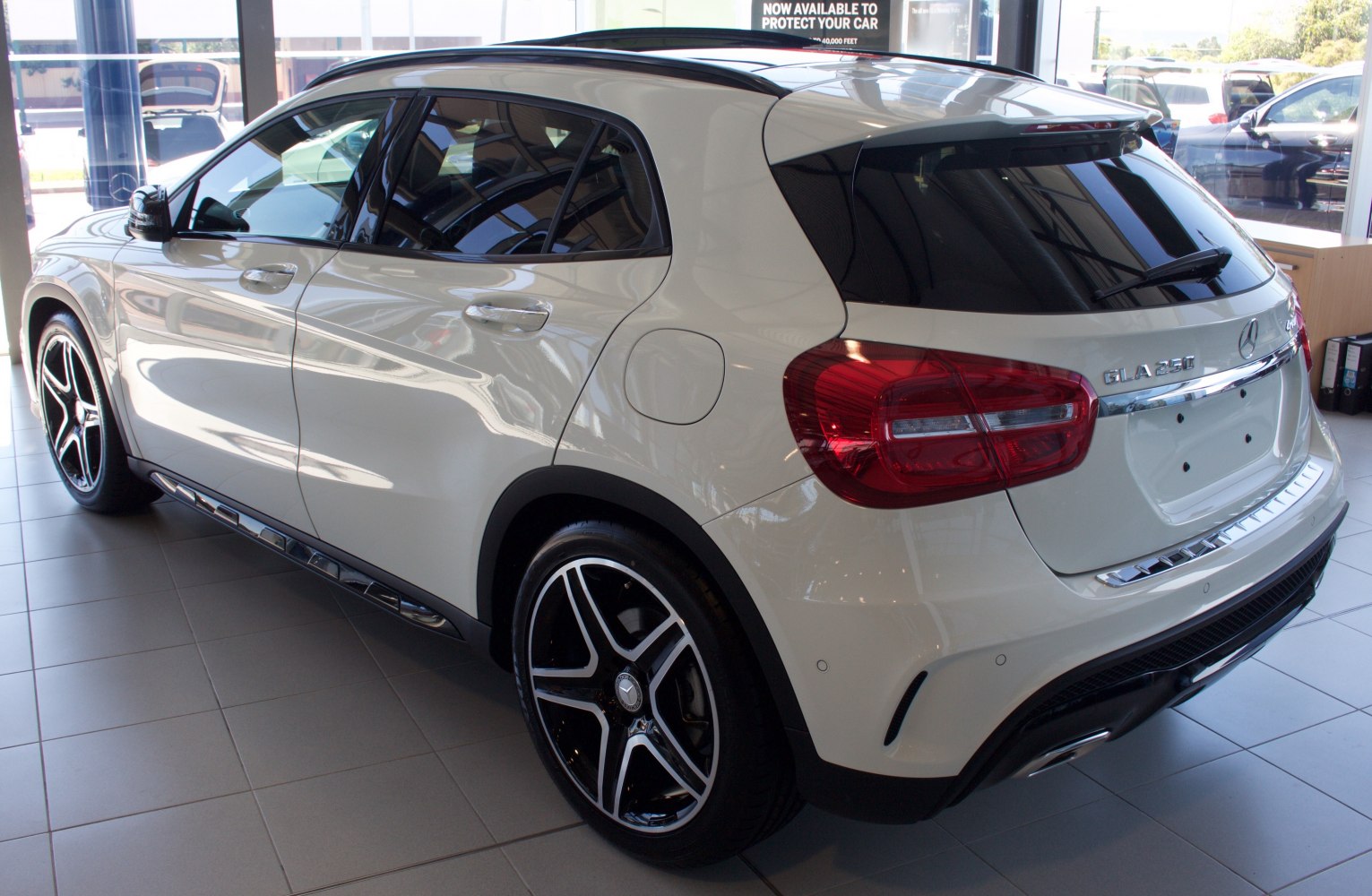 Rear side of white compact SUV with alloy wheels and tinted windows