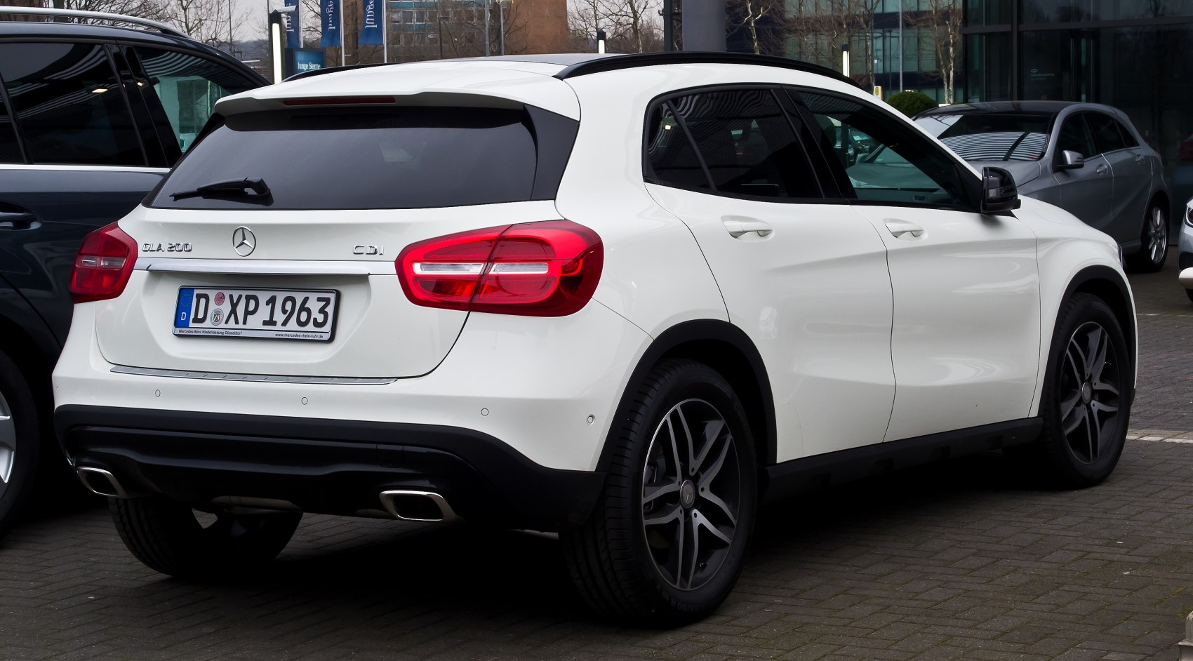 White SUV rear with dual exhaust and tinted rear windows