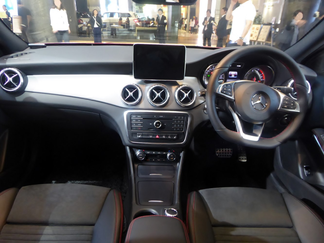 Dashboard layout with circular air vents and multifunction steering wheel