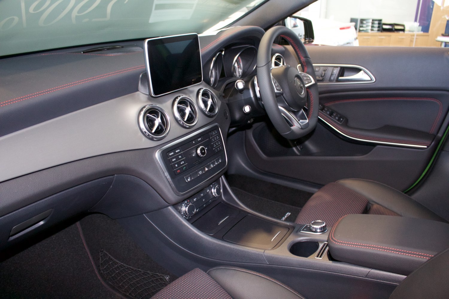 Dashboard and steering wheel with premium materials and infotainment screen