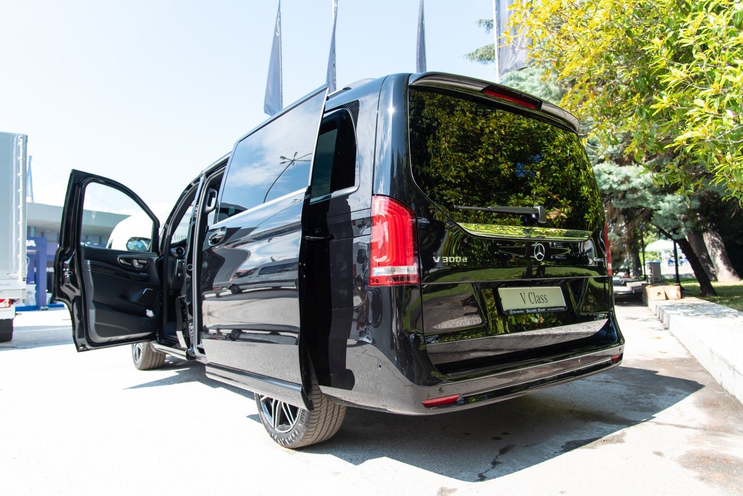 Rear and side view of a luxury van with open front and sliding doors