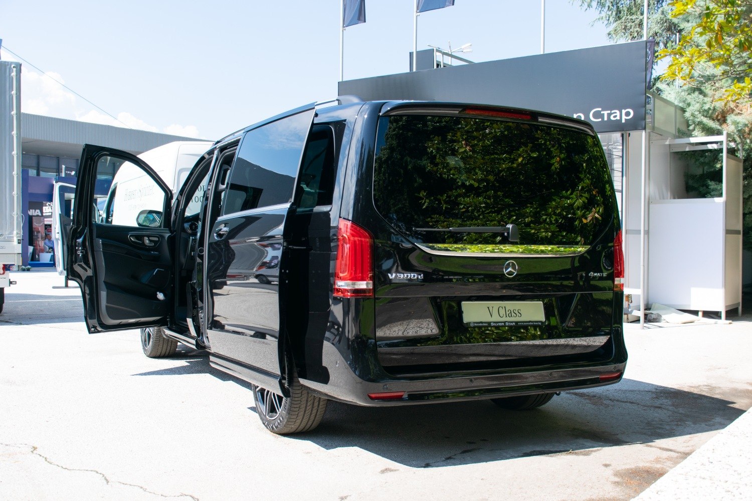 Rear and side view of black van with open doors