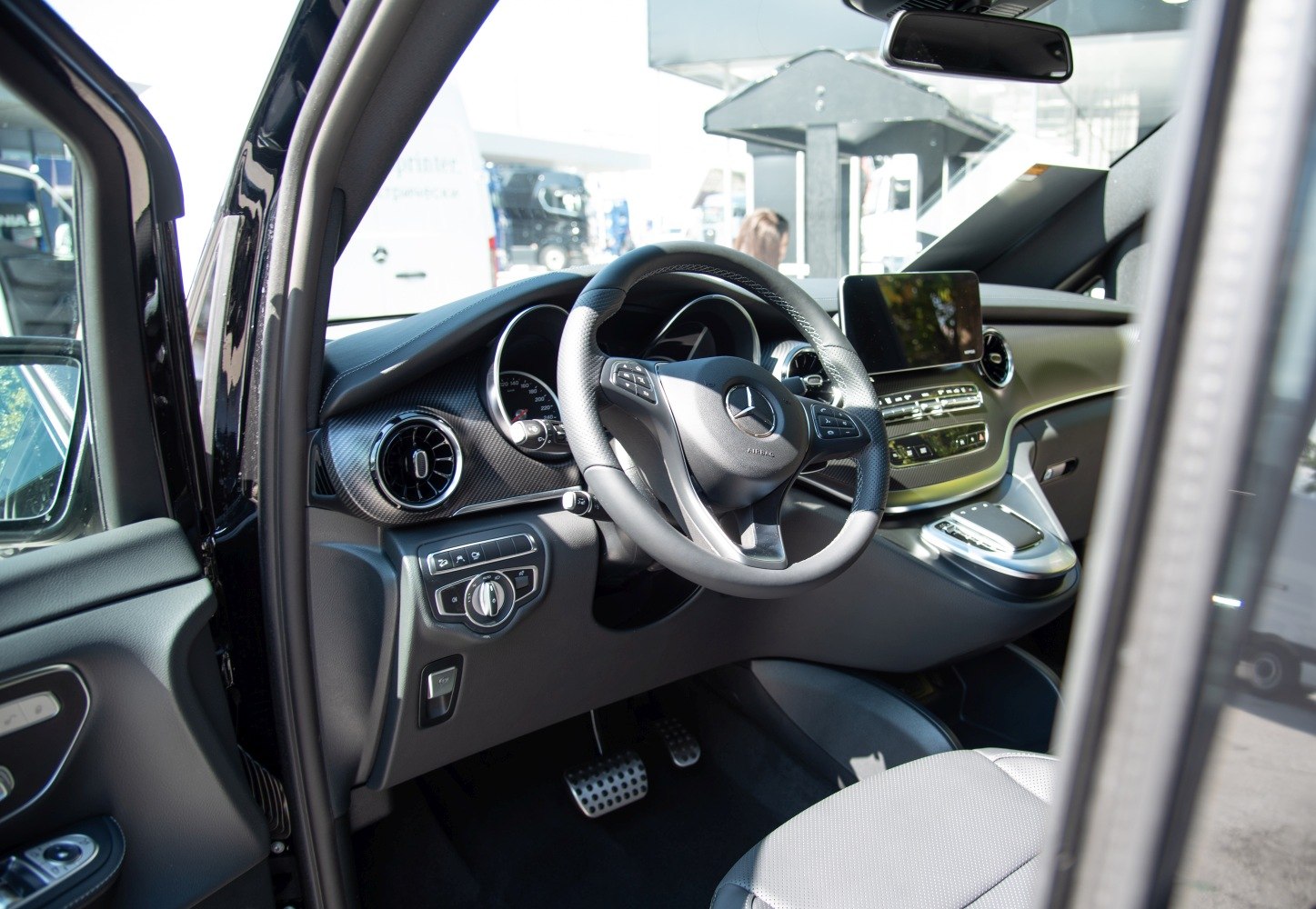 Steering wheel and dashboard interior with touchscreen and control panels