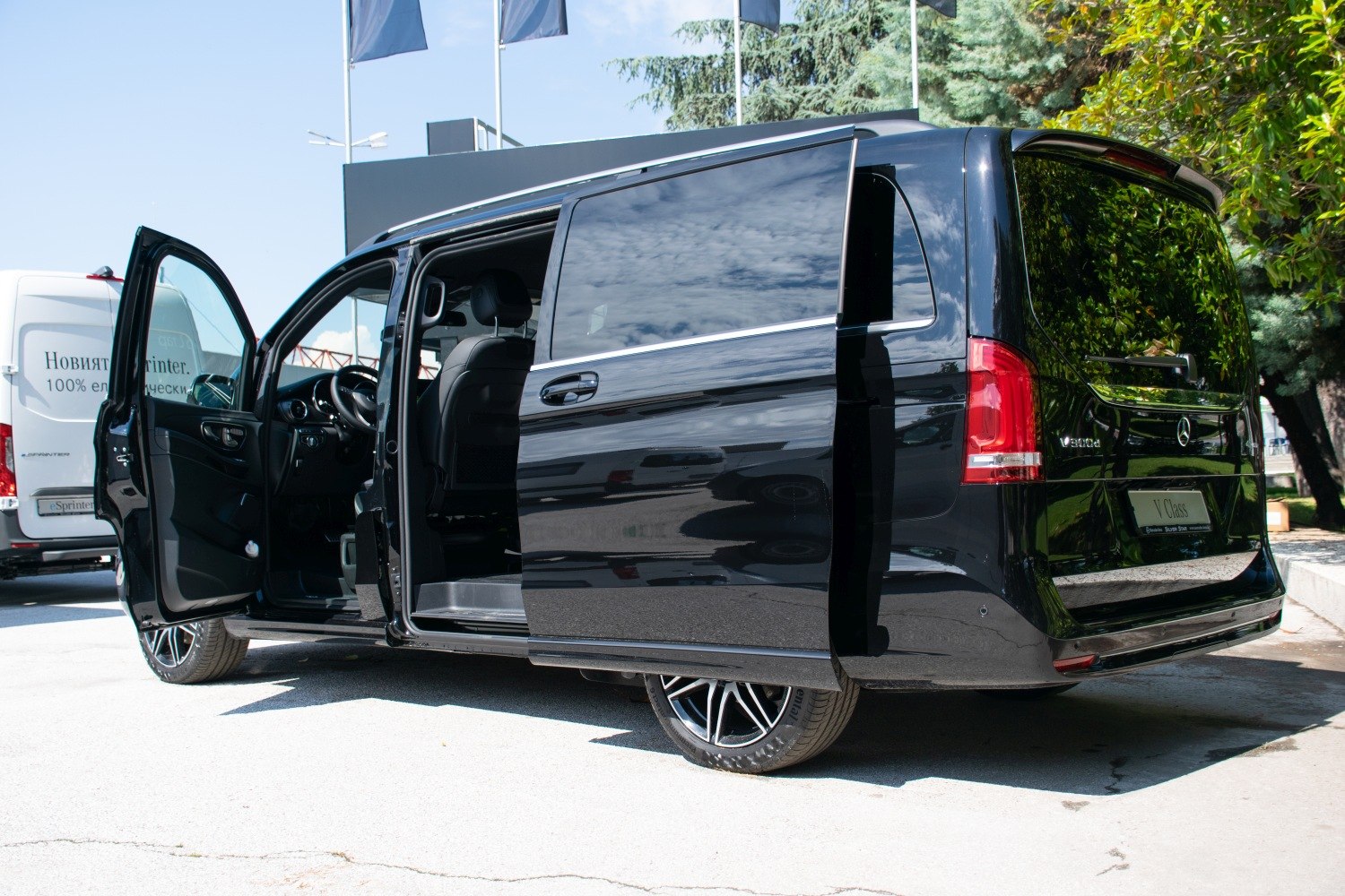 Black van with open sliding side door and front door.