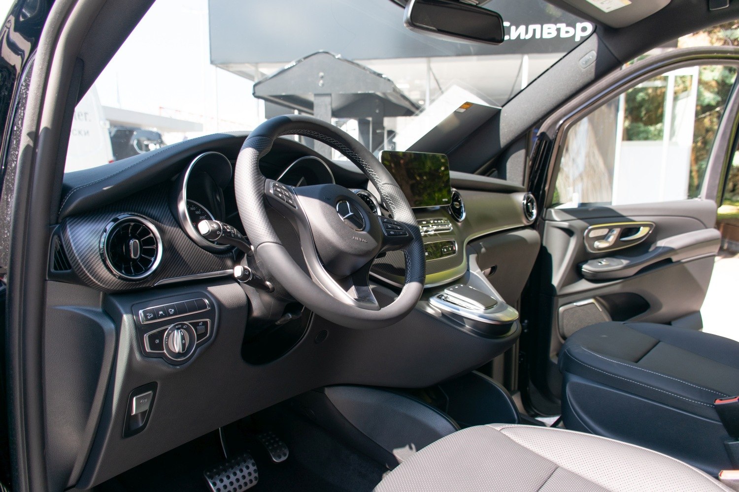 Modern interior dashboard with multifunction steering wheel and digital display.