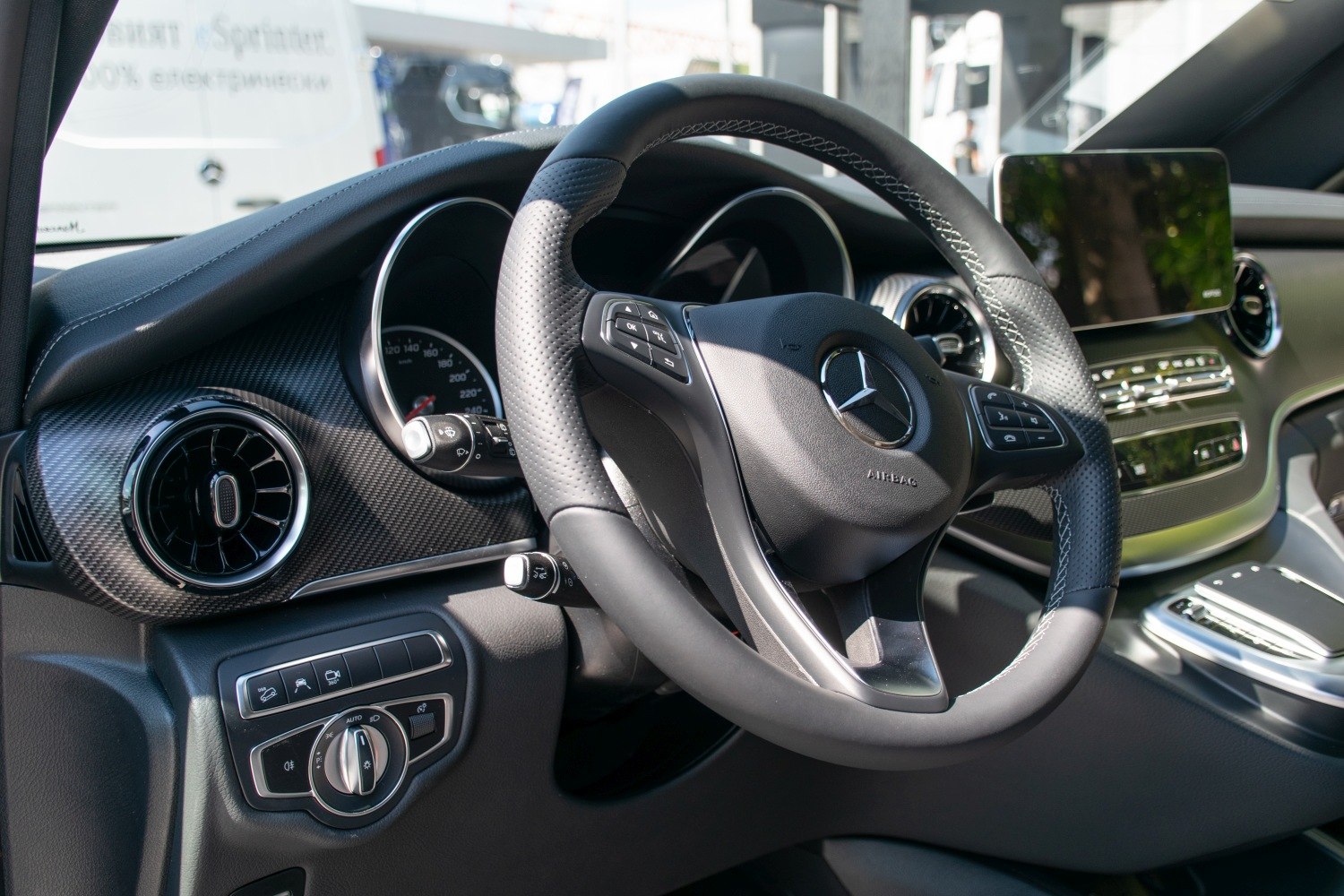 Steering wheel and dashboard with digital display in a luxury van interior