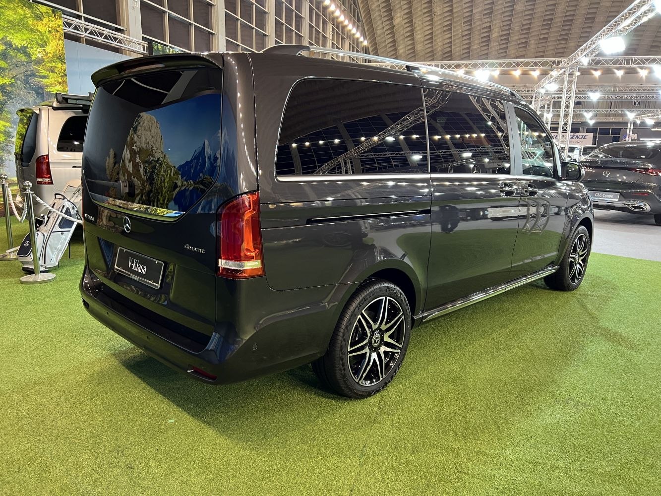 Rear side view of minivan with tinted windows and alloy wheels