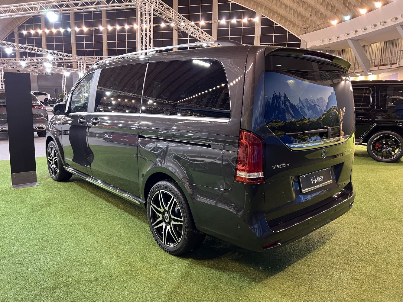 Rear-side view of a long-wheelbase luxury van with alloy wheels.