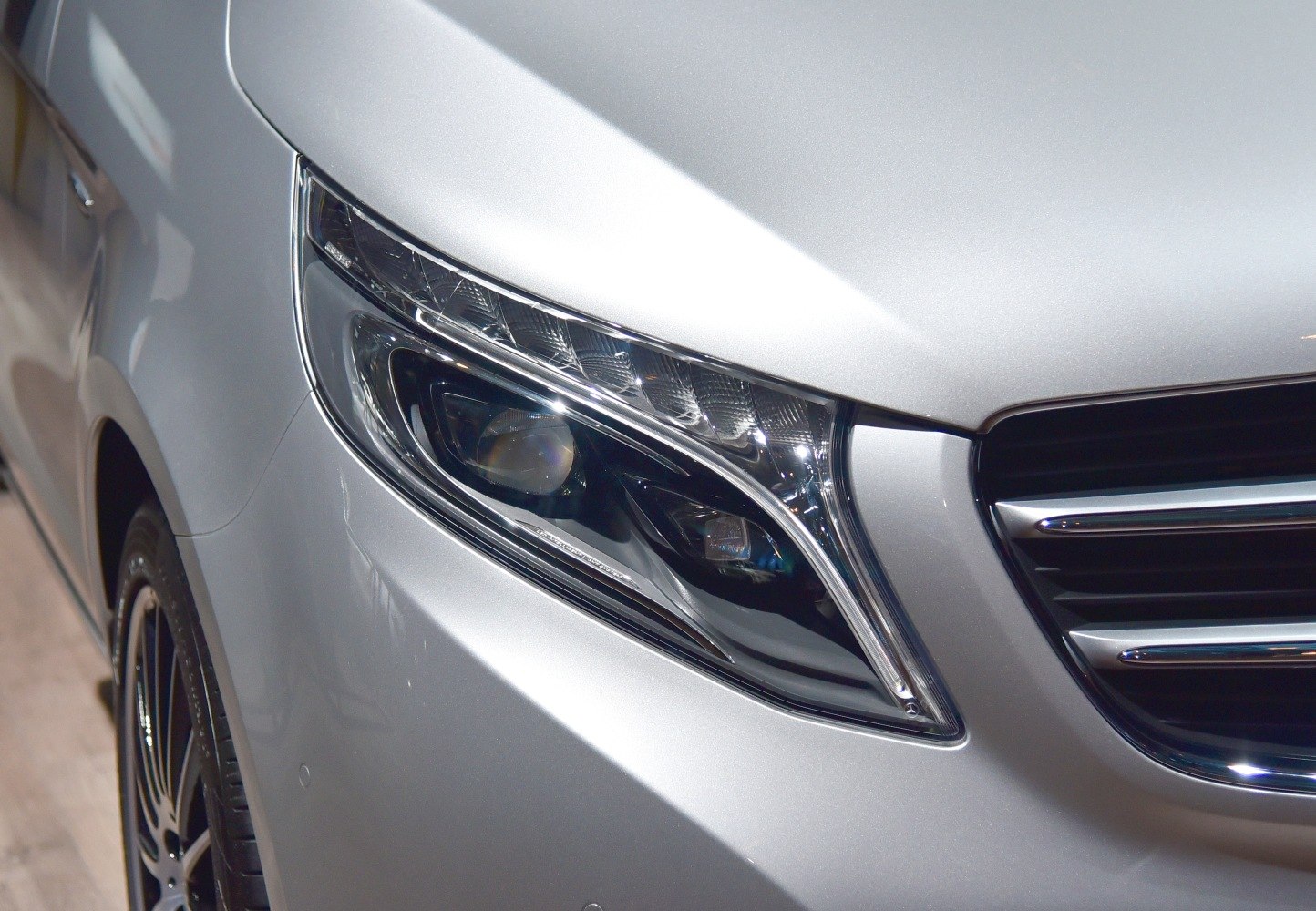Close-up of LED headlight with sharp lines and chrome grille edge
