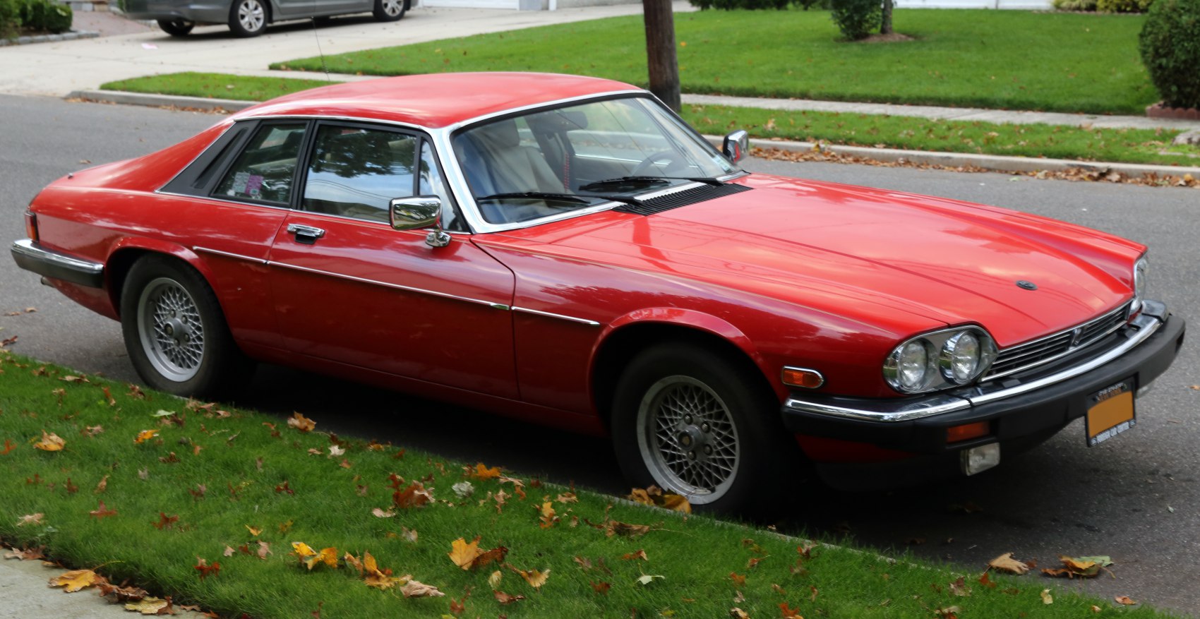 Red luxury coupe with wire-spoke wheels and classic 1970s sports design