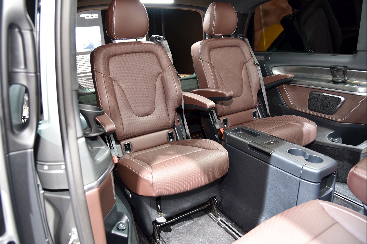 Brown leather captain seats with armrests and modern center console