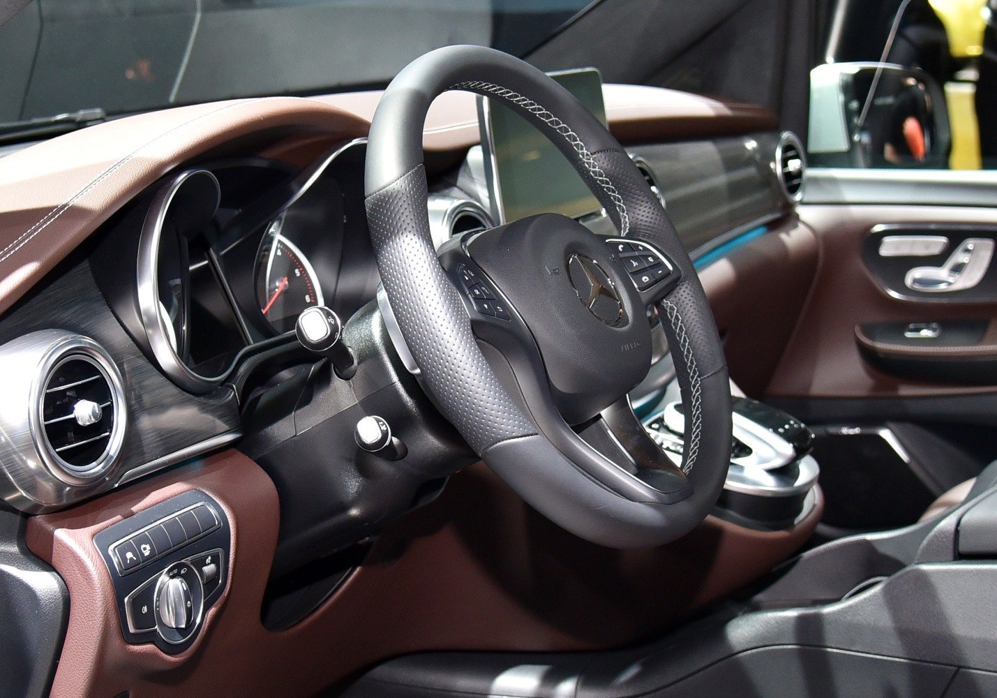 Leather steering wheel with multifunction controls and modern dashboard design.