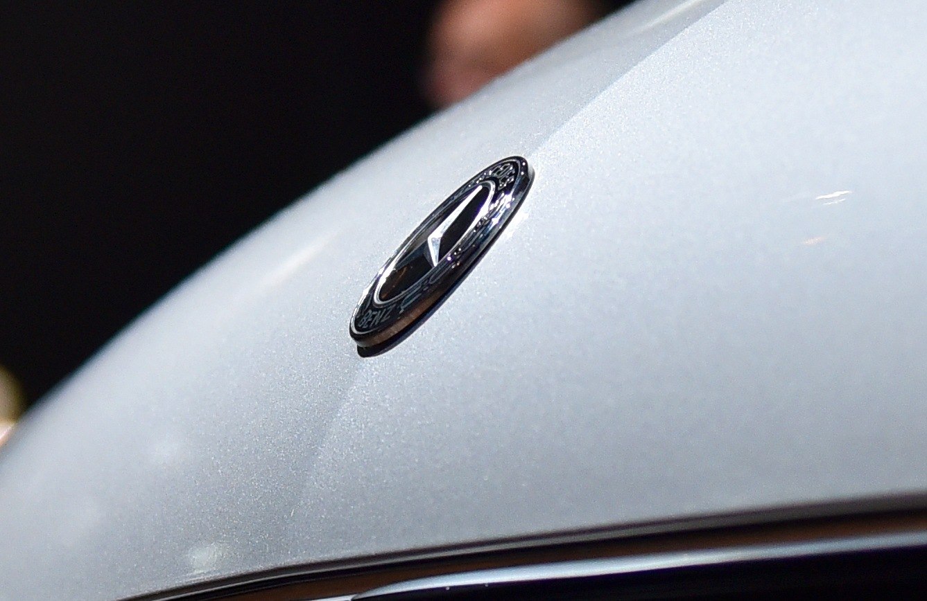 Close-up of Mercedes-Benz star emblem on a metallic car surface
