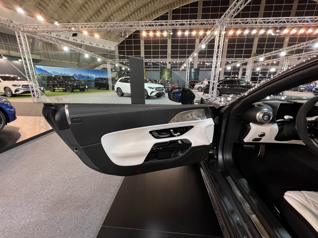 Luxury car door interior panel with control buttons and metallic trim