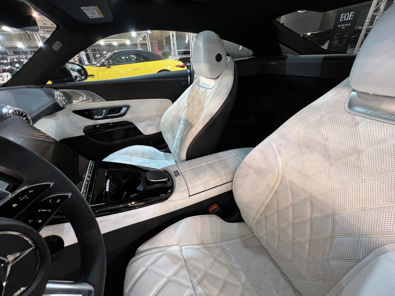 Luxurious white quilted leather seats with perforated detailing and sleek central console.