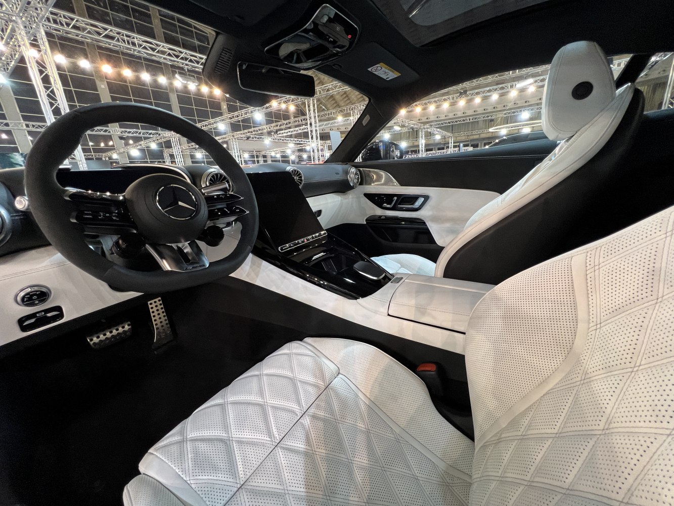 Diamond-stitched white leather seats and digital cockpit interior