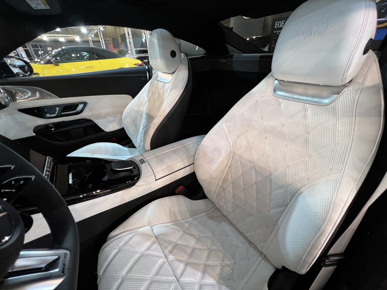 Luxurious white leather perforated AMG-branded sports seats interior
