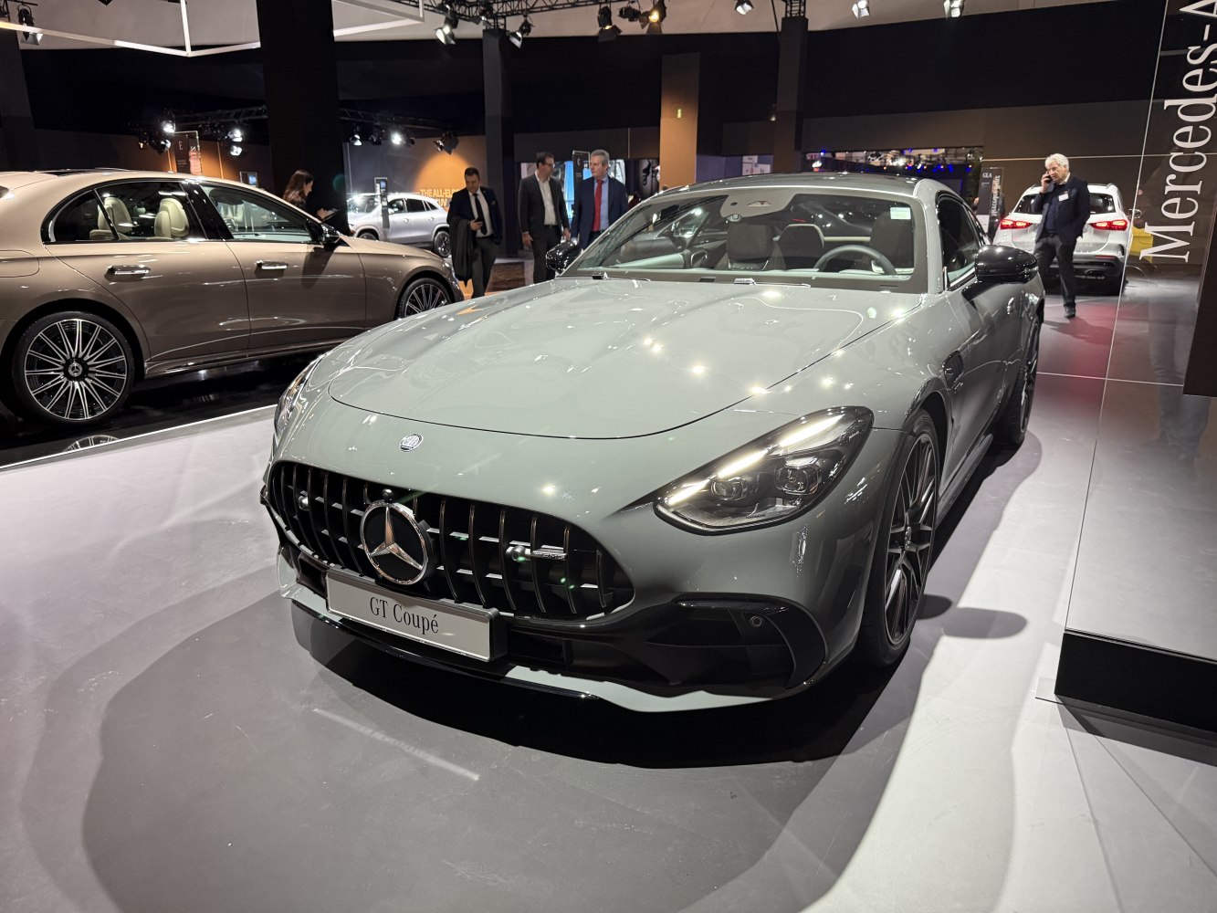 Front view of a modern luxury coupe with aggressive grille and sleek LED headlights.